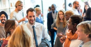 Group of smiling event attendees mingling