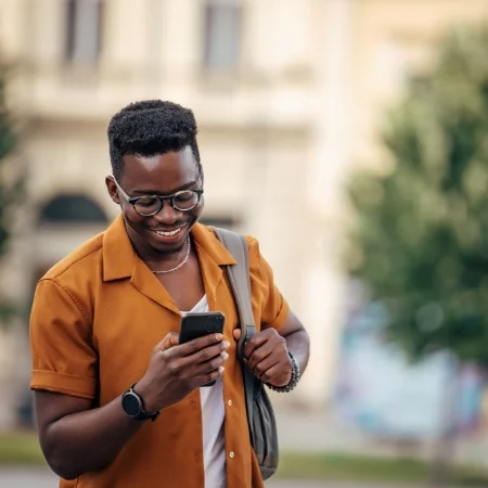 Person walking and texting on their phone.