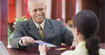 two people exchanging a document