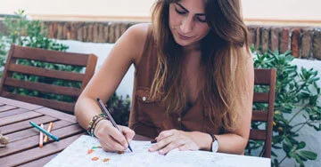 person coloring in a coloring book