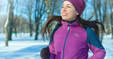 person jogging wearing an embroidered sweatshirt