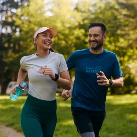 Two smiling joggers wearing branded T-shirts