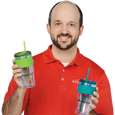 Employee holding a drinkware item that includes a reusable tumbler and straw