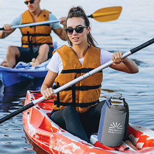 Two people kayaking with a Koozie cooler