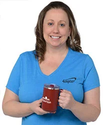 4imprint employee Shelli holding a Crossland Vacuum Camp Mug