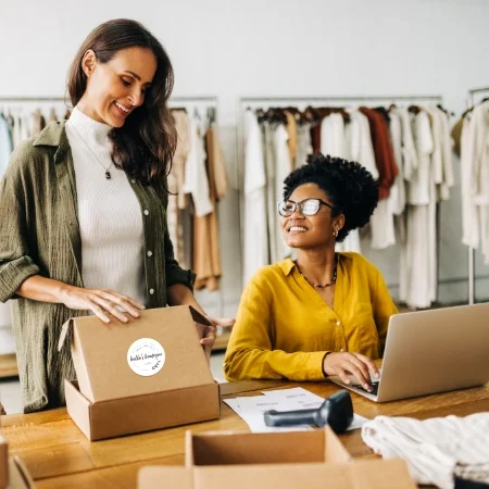 Two people fulfilling orders for a clothing boutique.