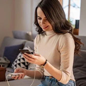 Woman charging phone with a wireless charger