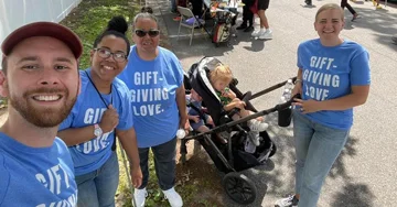 Group of people at a charity walk with branded t-shirts