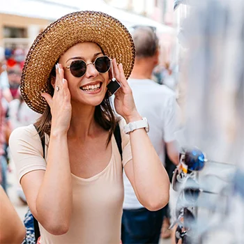 A woman trying on sunglasses in a crowd