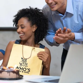 A woman receiving a gift in a bag at the office
