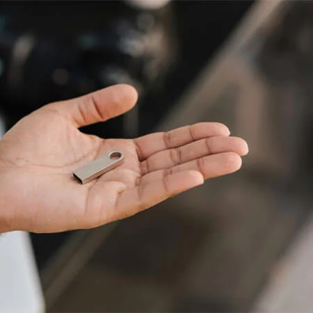 Man showing USB stick on hand