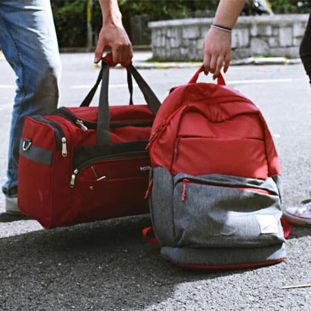 Two Person Carrying Duffel and Backpack