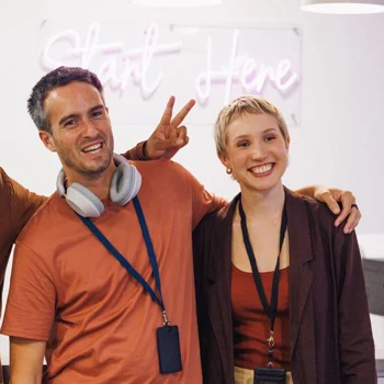 two people smiling at a group event