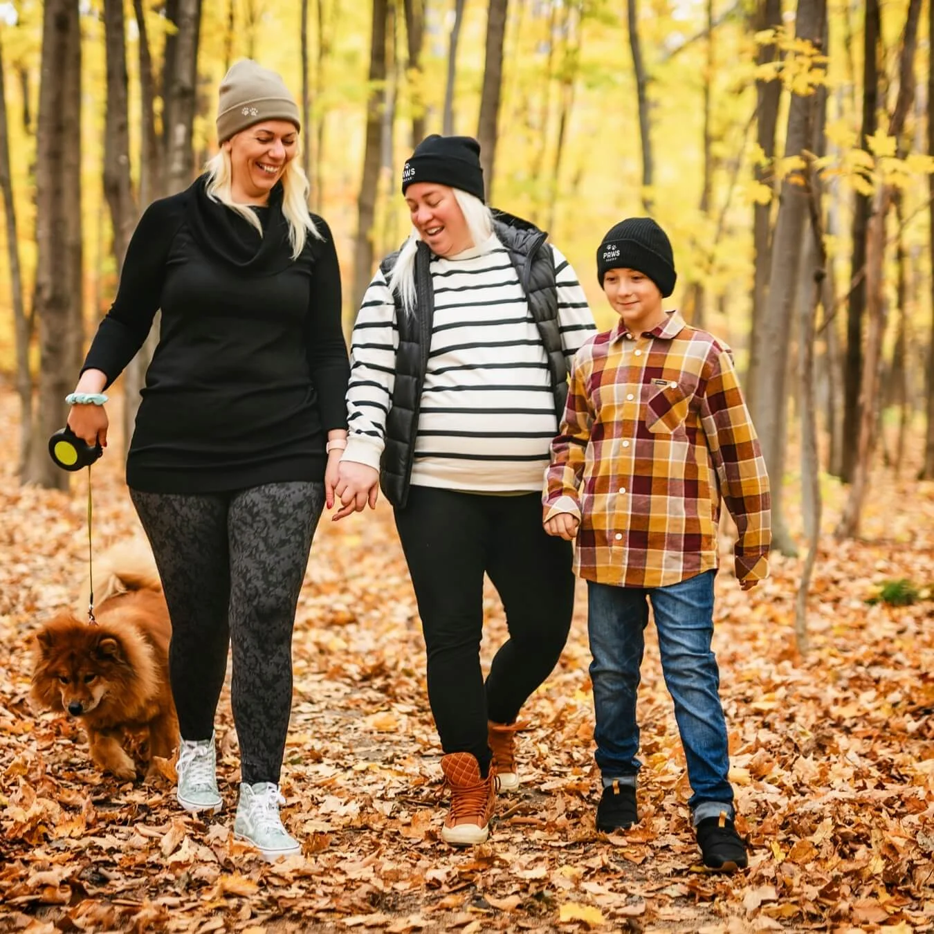 Family walking in the woods during the fall season.