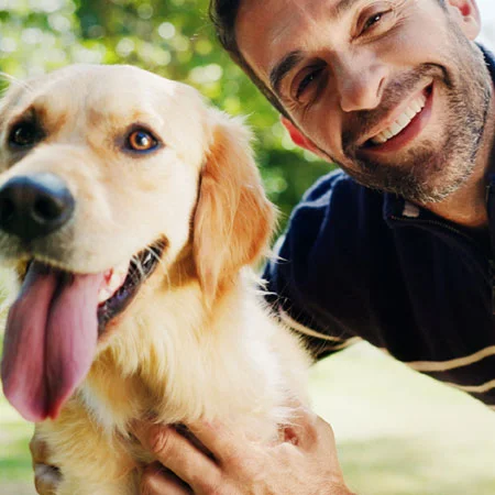 photo of a man with a golden retriever dog