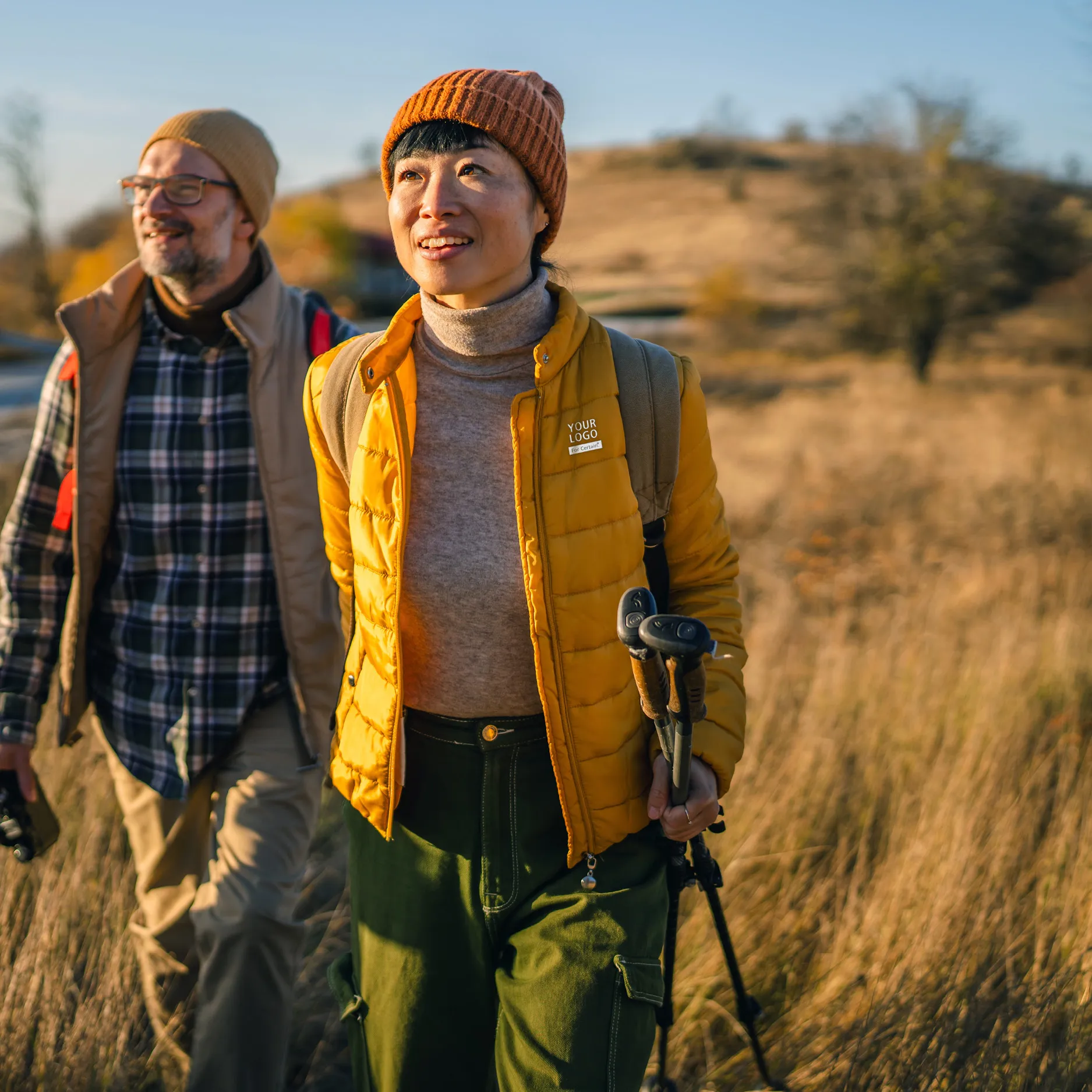 two people walking through a field