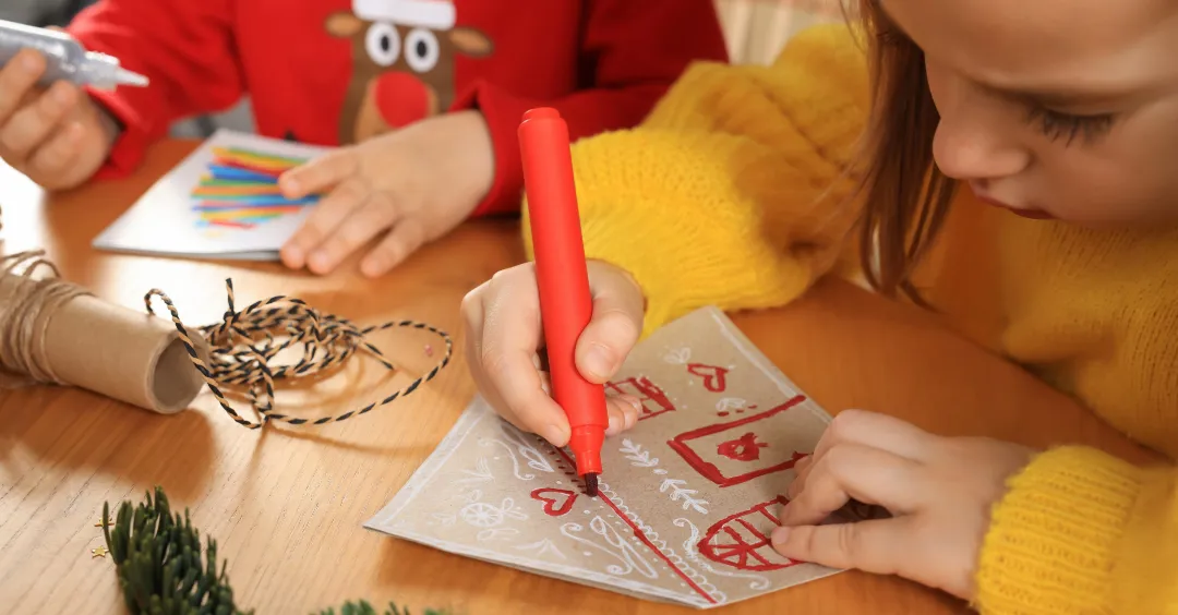 Two students doing holiday crafts at school.