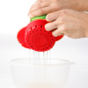 a person pouring liquid into a bowl