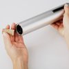 a person holding a roll of foil