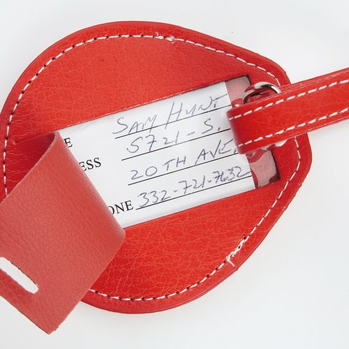 Additional Image 2 - a red luggage tag with a white tag