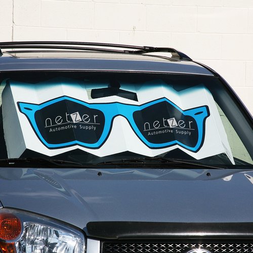 Additional Image 2 - a car with sunglasses on the windshield