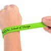 a person's hand holding a green wristband