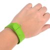 a person wearing a green wristband