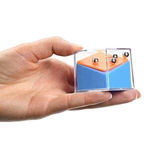 Additional Image 4 - a hand holding a small blue and orange cube