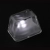 a clear plastic cube with a light reflecting off it