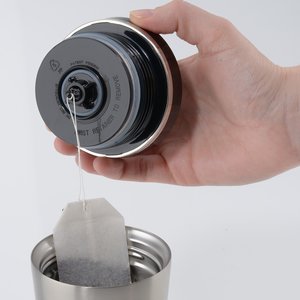 Additional Image 1 - a hand holding a can of coffee