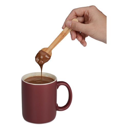 Additional Image 2 - a hand holding a spoon over a cup of coffee