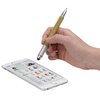 a hand holding a pen and writing on a remote control