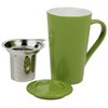 a green mug with a spoon and a small cup