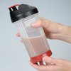a person holding a shaker