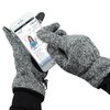 a person wearing gloves holding a small object