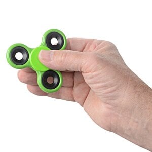 Additional Image 1 - a hand holding a green and black fidget spinner