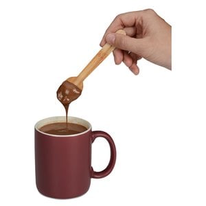 Additional Image 2 - a hand holding a spoon over a cup of coffee