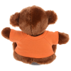 a stuffed animal wearing an orange shirt