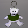 a white stuffed bear with green shirt