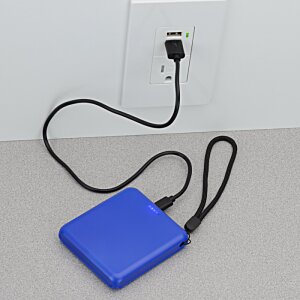 a blue rectangular object with a black cord plugged into a wall