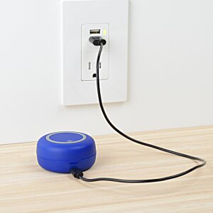Additional Image 4 - a blue round object with a black cord plugged into a wall outlet