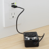 a black electrical device plugged into a wall