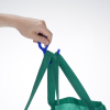 a hand holding a green bag
