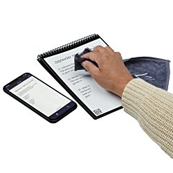 a hand holding a pen and a tablet