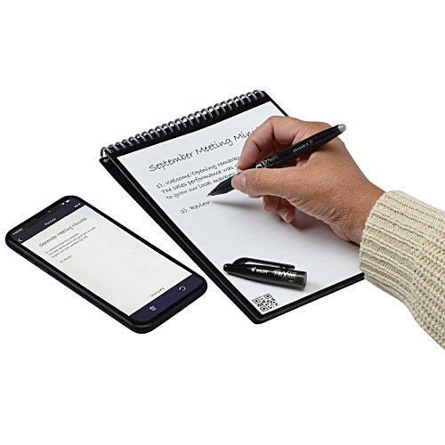Additional Image 4 - a hand writing on a paper next to a cell phone
