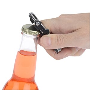 Additional Image 7 - a hand opening a bottle of orange liquid