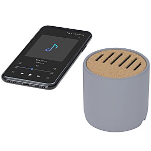 Additional Image 2 - a black cell phone next to a round speaker