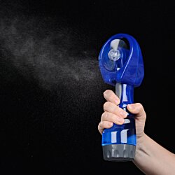 a hand holding a blue object with steam coming out of it