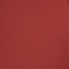 a red wall with a black and white object in the middle