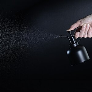 Additional Image 3 - a person spraying a black object